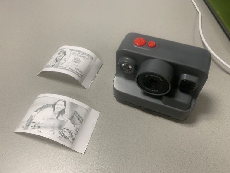 a camera and two photos on a table