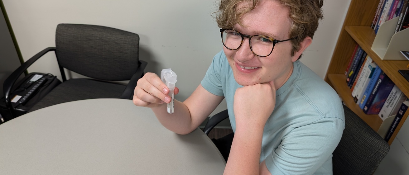 Boy holding tube