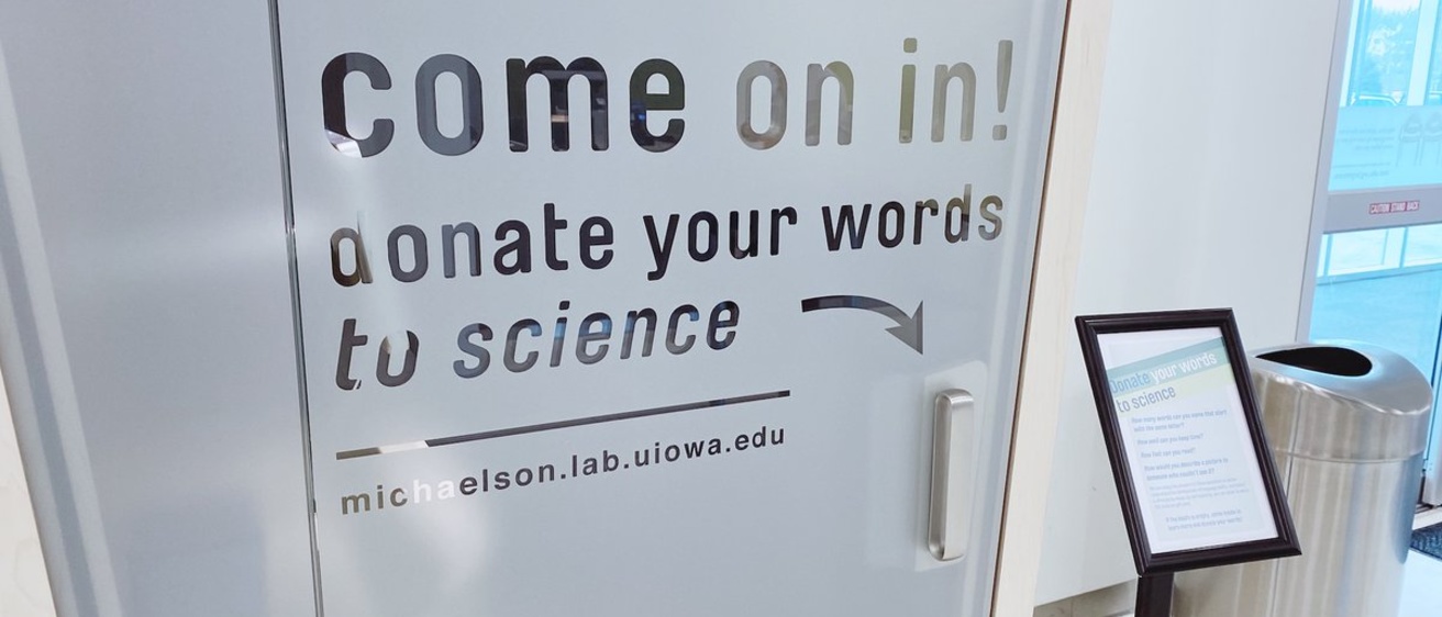 Booth that says come on in and donate your words to science